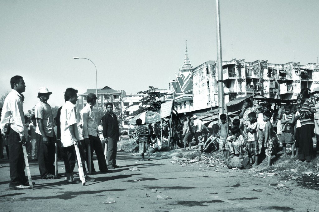 Children of the Dey Krahrom community, nervous about the hired men with demolition bars.