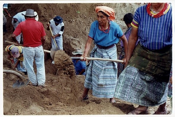 Community members exhume the bodies of people killed in the violent massacres of the 1980’s and 90’s. Photo: Bert Hanson.
