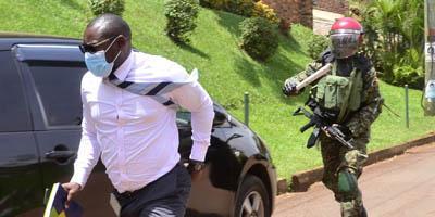 A Ugandan Military police officer chasing a journalist who was covering Bobi Wine when he had taken a petition to the UN human rights Kampala office protesting continued human rights violations and the illegal detention of his supporters. Photo: Lawrence Kitatta