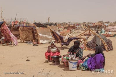 Newly arrived Sudanese refugees shelter outdoors in extreme heat at the Tine border in Chad.