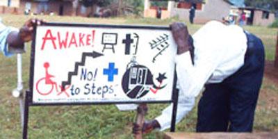 Uganda-innovative-advocacy, putting up a sign protesting lack of wheelchair access